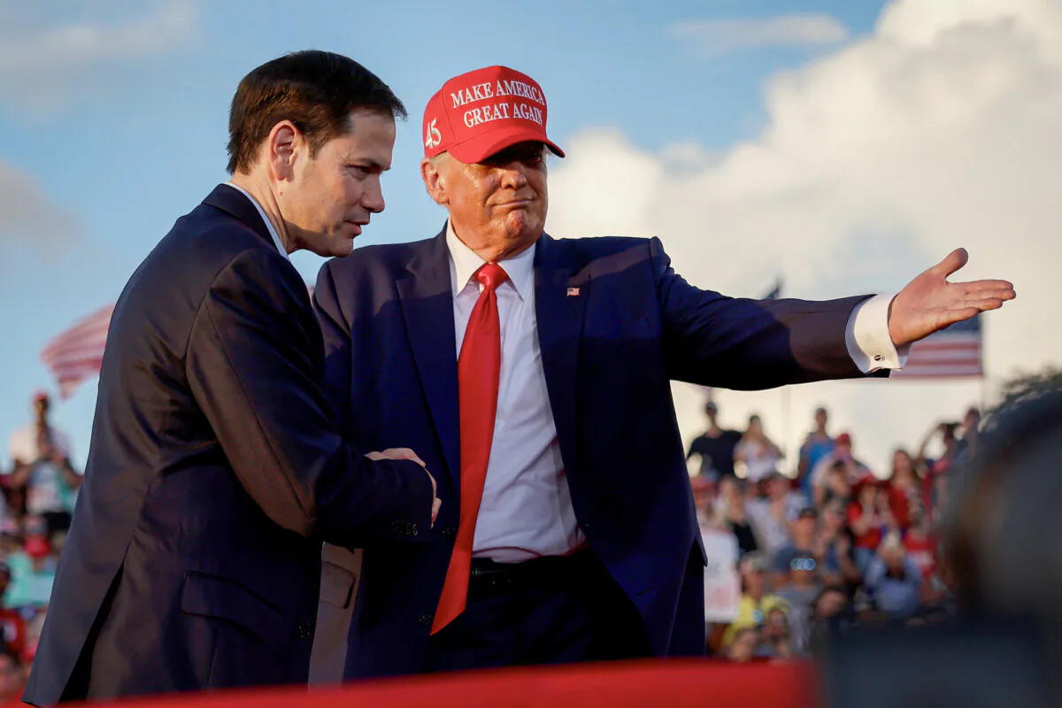 Former U.S. President Donald Trump invites Sen. Marco Rubio (R-Fla.) to speak at the microphone during a rally at the Miami-Dade County Fair and Exposition in Miami on Nov. 6, 2022. (Joe Raedle/Getty Images)