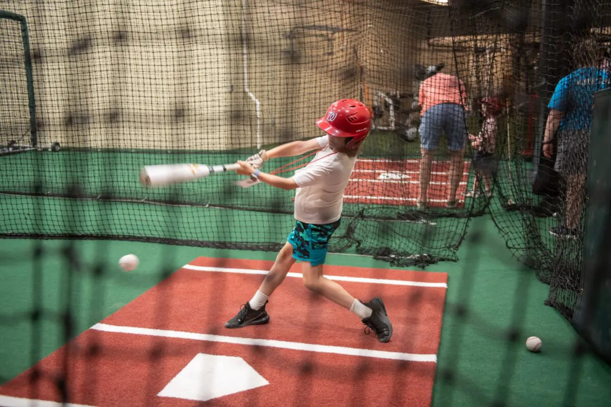 A child takes a turn in the batting cage at Nationals Park in Washington on July 10, 2024. (Jenn Reid/Horton's Kids)