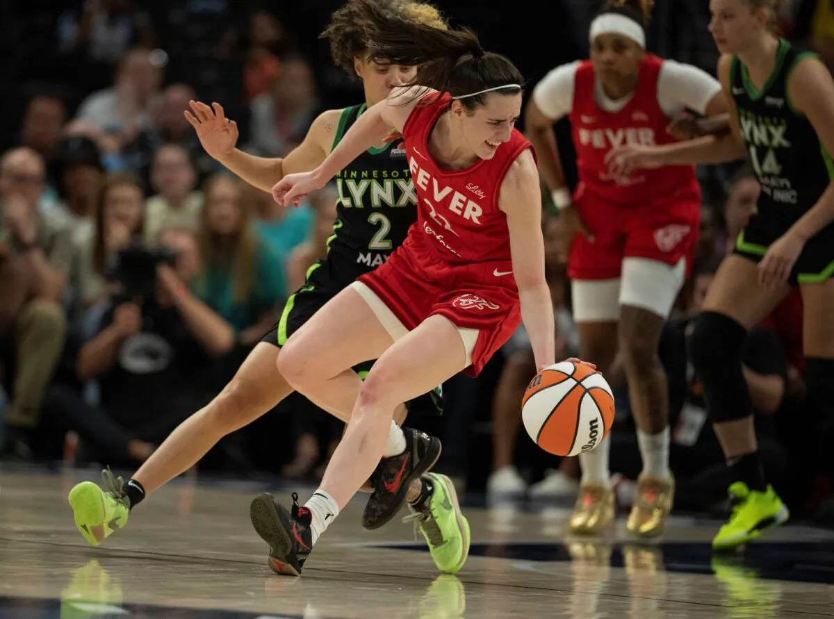 The Indiana Fever's Caitlin Clark dribbles under pressure from Natisha Hiedeman of the Minnesota Lynx during a WNBA game in Minneapolis on July 14, 2024. (Jerry Holt/Star Tribune via AP)