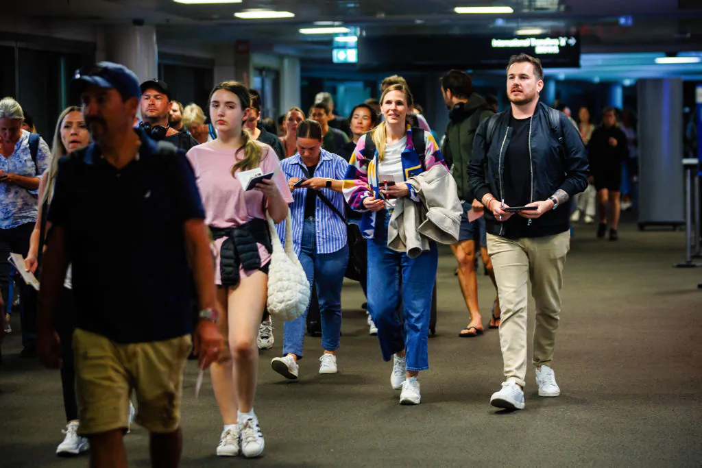 Passengers are seen after disembarking a French Government flight arriving from Noumea at Brisbane International Airport in Brisbane, Australia, on May 22, 2024. (Patrick Hamilton/POOL/AFP via Getty Images)