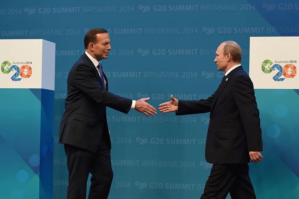 Australia's Prime Minister Tony Abbott (L) prepares to shake hands with Russia's President Vladimir Putin during the G20 Summit in Brisbane, Australia, on Nov. 15, 2014. (WILLIAM WEST/AFP via Getty Images)