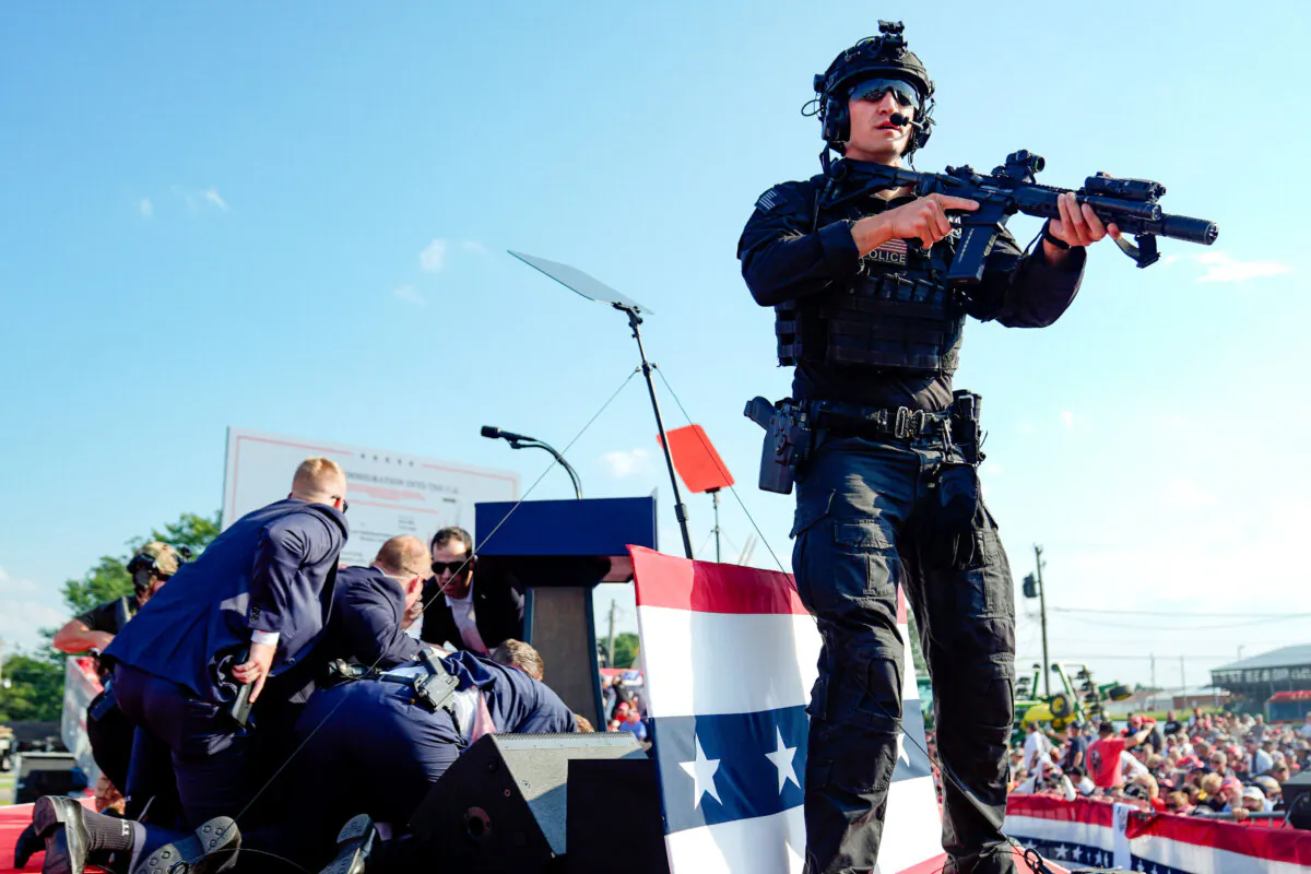 Republican presidential candidate former President Donald Trump is covered by Secret Service agents at a campaign rally in Butler, Pa., on July 13, 2024. (Evan Vucci/AP Photo)