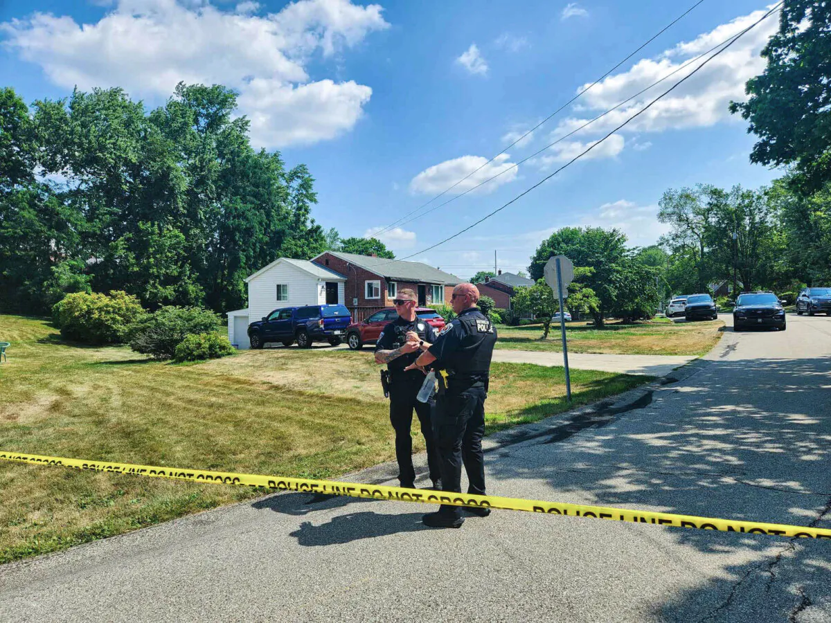 Police officers talk in front of the home where Thomas Matthew Crooks lived with his parents in Bethel Park, Pa., on July 15, 2024. (Jeff Louderback/Epoch Times)