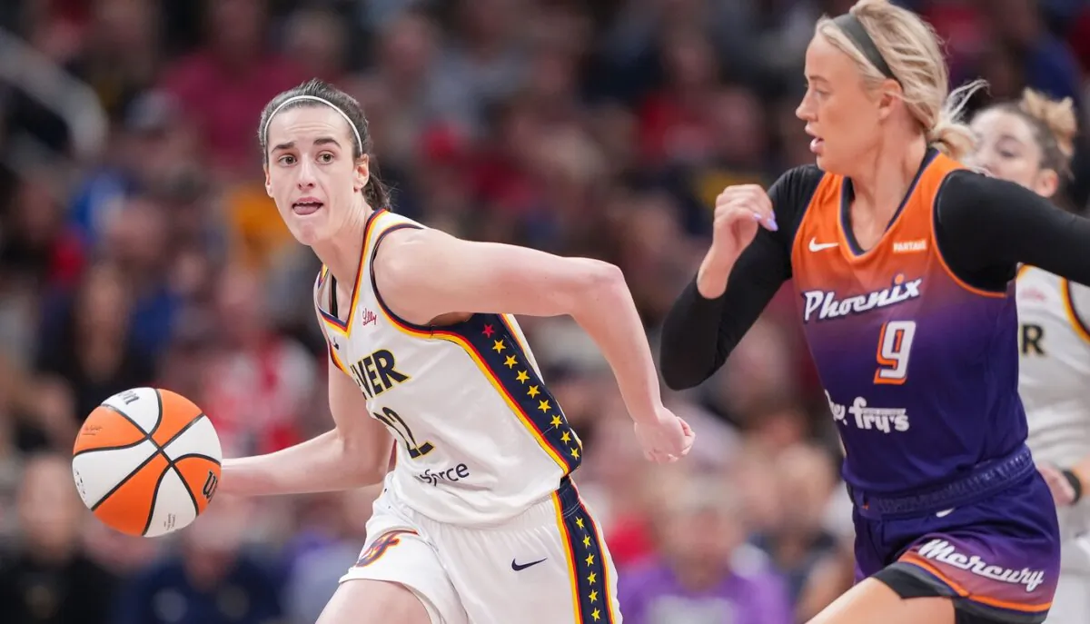 Caitlin Clark (L) of the Indiana Fever races up the court ahead of the Phoenix Mercury's Sophie Cunningham in Indianapolis on July 12, 2024. (Grace Hollars/Indianapolis Star via Field Level Media)
