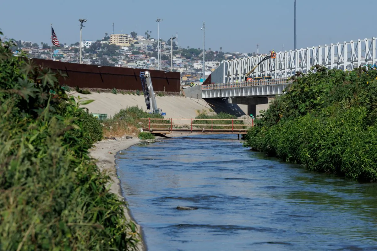 Raw sewage flows along the Tijuana river, located between the primary and secondary borders next to Tijuana, Mexico, in San Diego on June 27, 2024. (Mike Bake/Reuters)