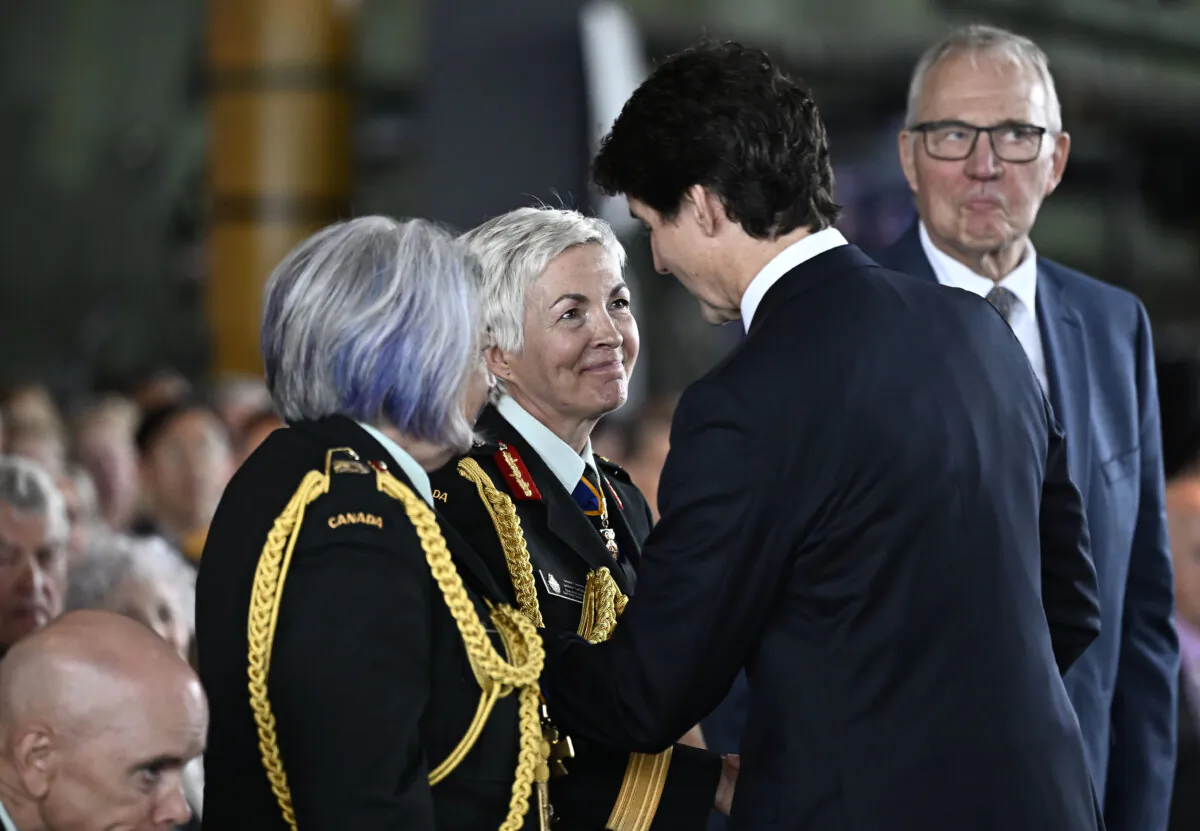Prime Minister Justin Trudeau shakes hands with Gen. Jennie Carignan, as Gov. Gen. Mary Simon, left, and Minister of National Defence Bill Blair, right, look on, during a change of command ceremony at the Canadian War Museum in Ottawa, on July 18, 2024. (THE CANADIAN PRESS/Justin Tang)