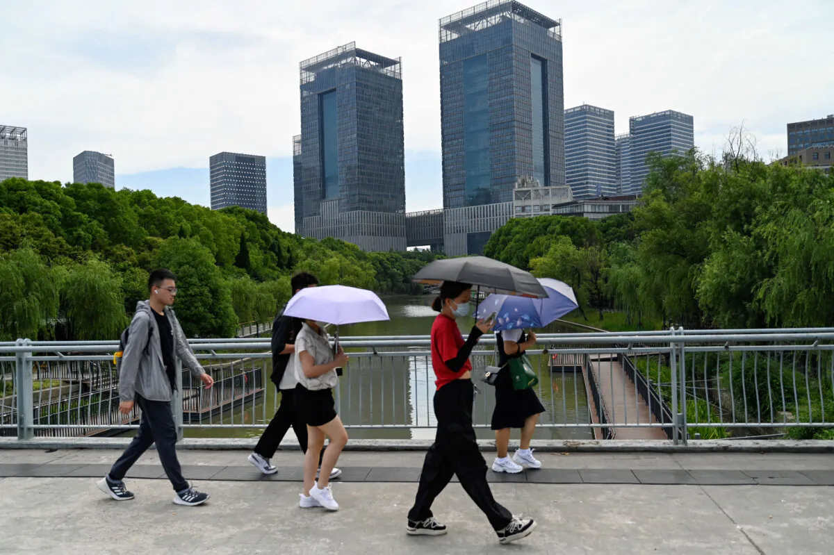 People walk on a street in Lujiazui district in Shanghai, China, on June 29, 2023. (Pedro Pardo/AFP via Getty Images)