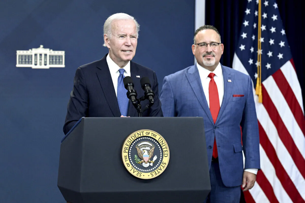 Education Secretary Miguel Cardona (right) looks on as President Joe Biden delivers remarks on the student debt relief portal beta test, in the South Court Auditorium of the Eisenhower Executive Office Building, next to the White House in Washington on Oct. 17, 2022. (Brendan Smialowski/AFP via Getty Images)