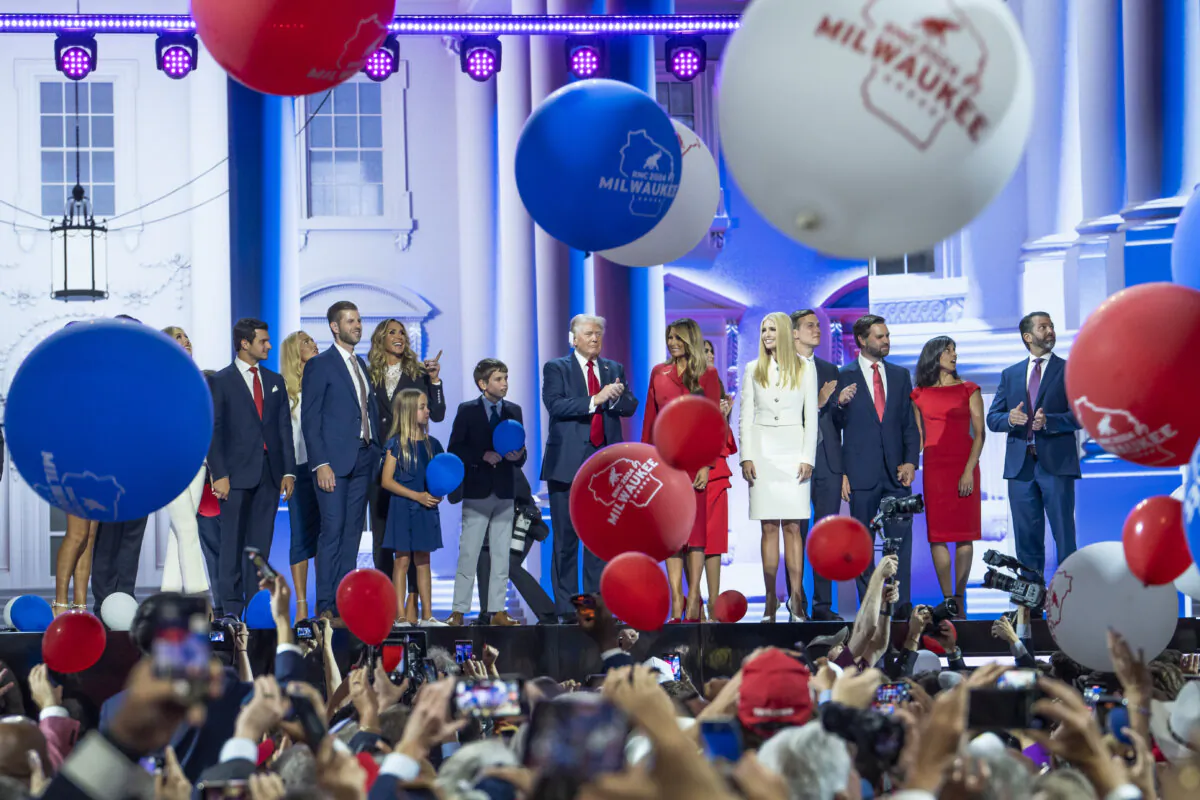 Former President Donald Trump, former First Lady Melania Trump, other family members, Republican vice presidential nominee Sen. JD Vance (R-Ohio), and his wife Usha Chilukuri Vance stand on stage on the last day of the RNC in Milwaukee on July 18, 2024. (Madalina Vasiliu/The Epoch Times)