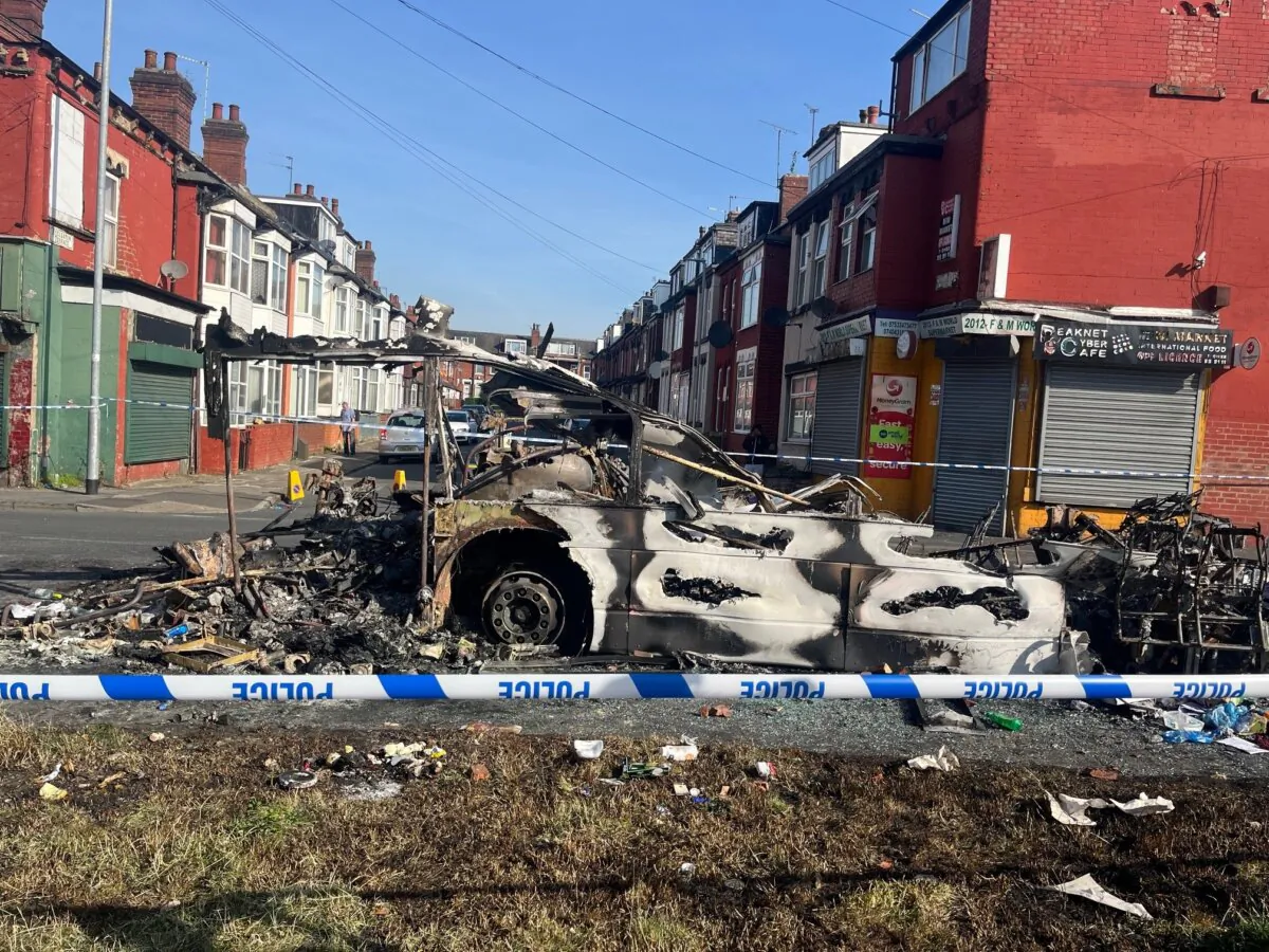 A burnt car in the Leeds suburb of Harehills, where a riot happened the night before, on July 19, 2024. (Katie Dickinson/PA Wire)