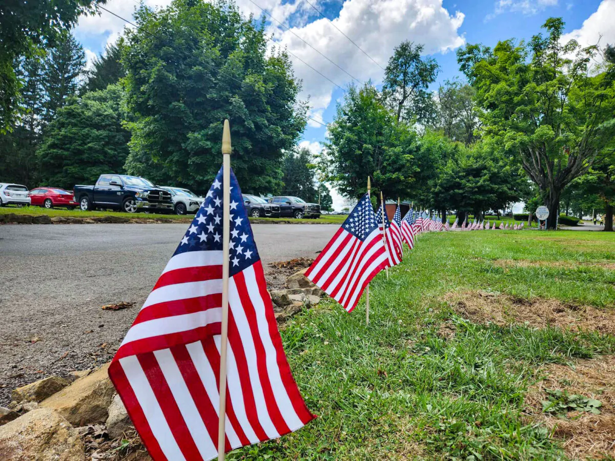American flags line the entrance to Freeport Community Park, where Corey Comperatore was remembered in two public viewings on July 18, 2024. (Jeff Louderback/Epoch Times)