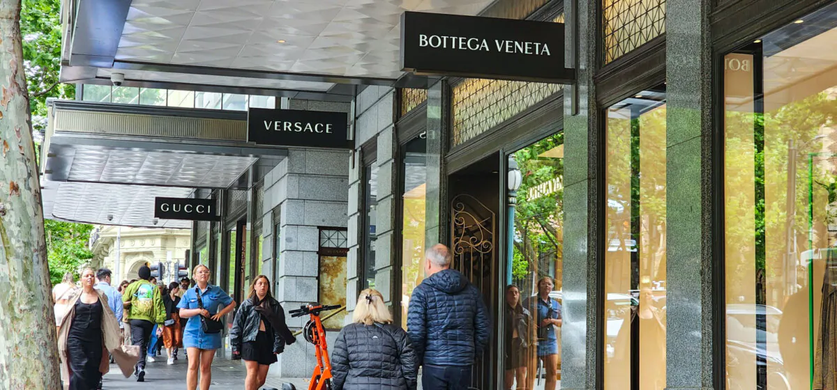 Shoppers walk past high-end brand stores in Melbourne, Australia, on Oct. 28, 2023. (Susan Mortimer/The Epoch Times)