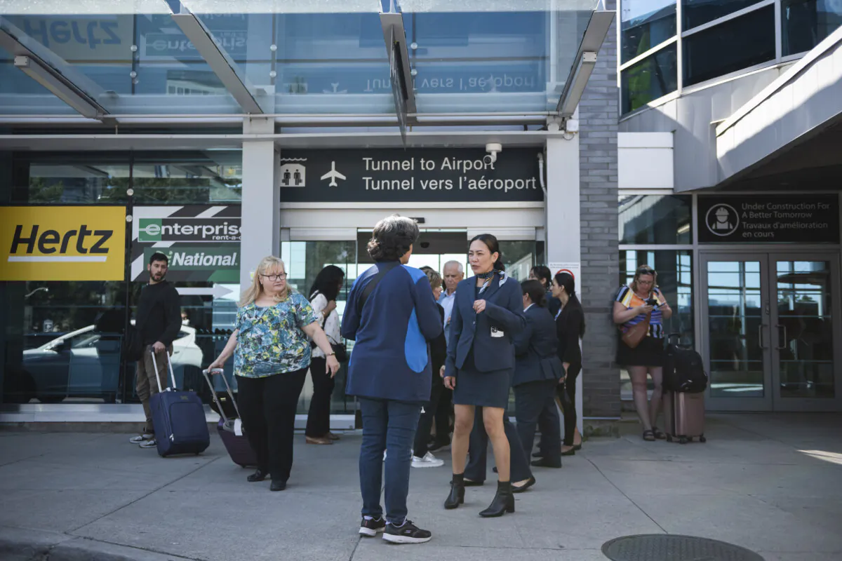 Porter Airlines staff direct travellers at Billy Bishop Airport in Toronto on Friday, July 19, 2024. Porter Airlines delayed flights as a global tech outage affected flights at the airline. (The Canadian Press/Christopher Katsarov)