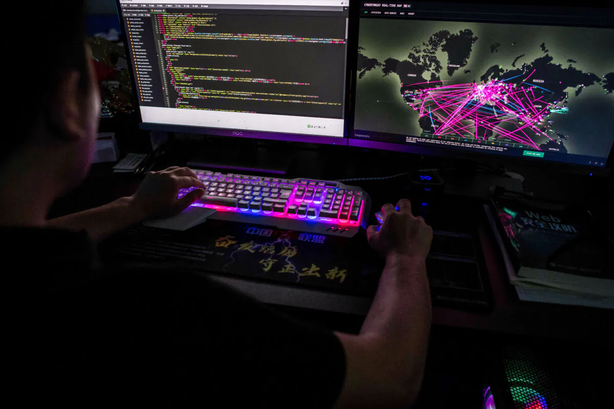 A member of the Red Hacker Alliance who refused to give his real name uses a website that monitors global cyberattacks at its office in Dongguan, Guangdong Province, China, on Aug. 4, 2020. (Nicolas Asfouri/AFP via Getty Images)