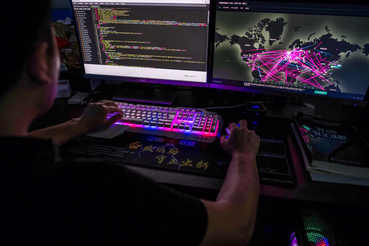 A member of the hacking group Red Hacker Alliance who refused to give his real name uses a website that monitors global cyberattacks on his computer at its office in Dongguan, Guangdong Province, China, on Aug. 4, 2020. (Nicolas Asfouri/AFP via Getty Images)