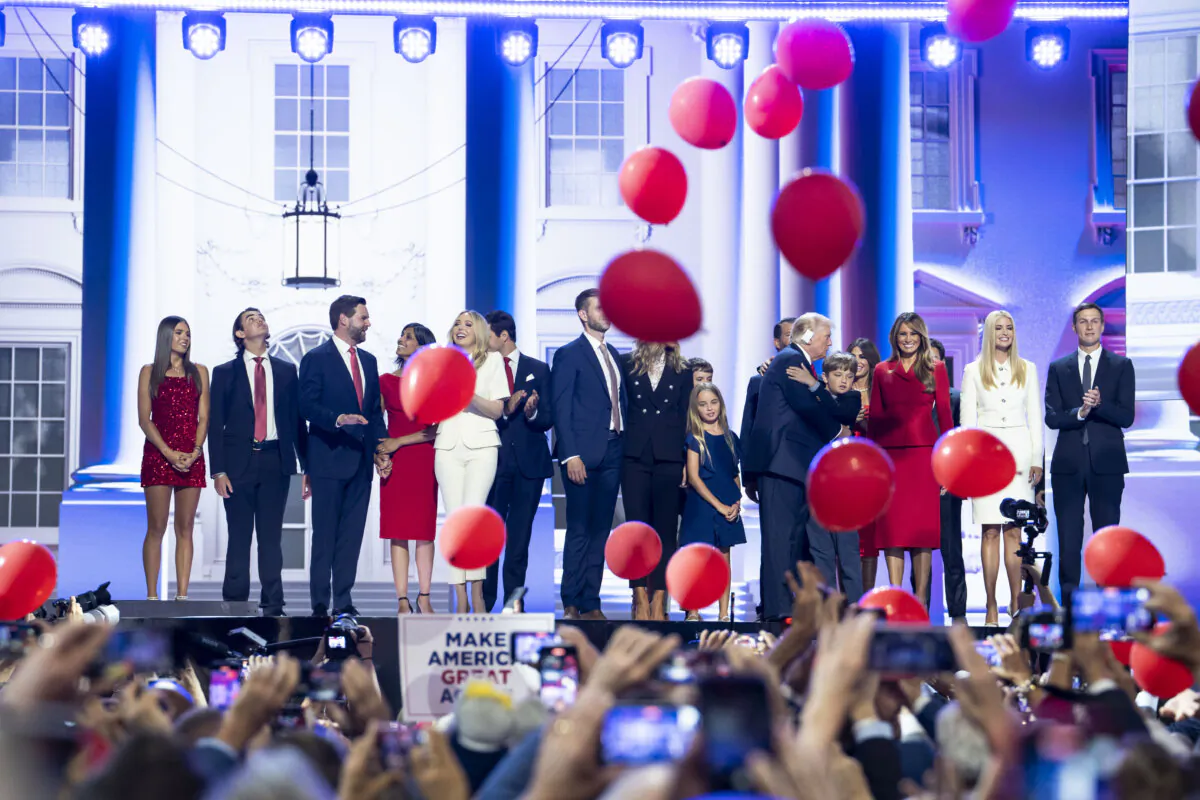 Former president Donald J. Trump, former first lady Melania Trump, other family members, Republican vice presidential nominee Sen. JD Vance (R-Ohio), and his wife Usha Chilukuri Vance stand on stage on the last day of the RNC in Milwaukee, Wis., on July 18, 2024. (Madalina Vasiliu/The Epoch Times)