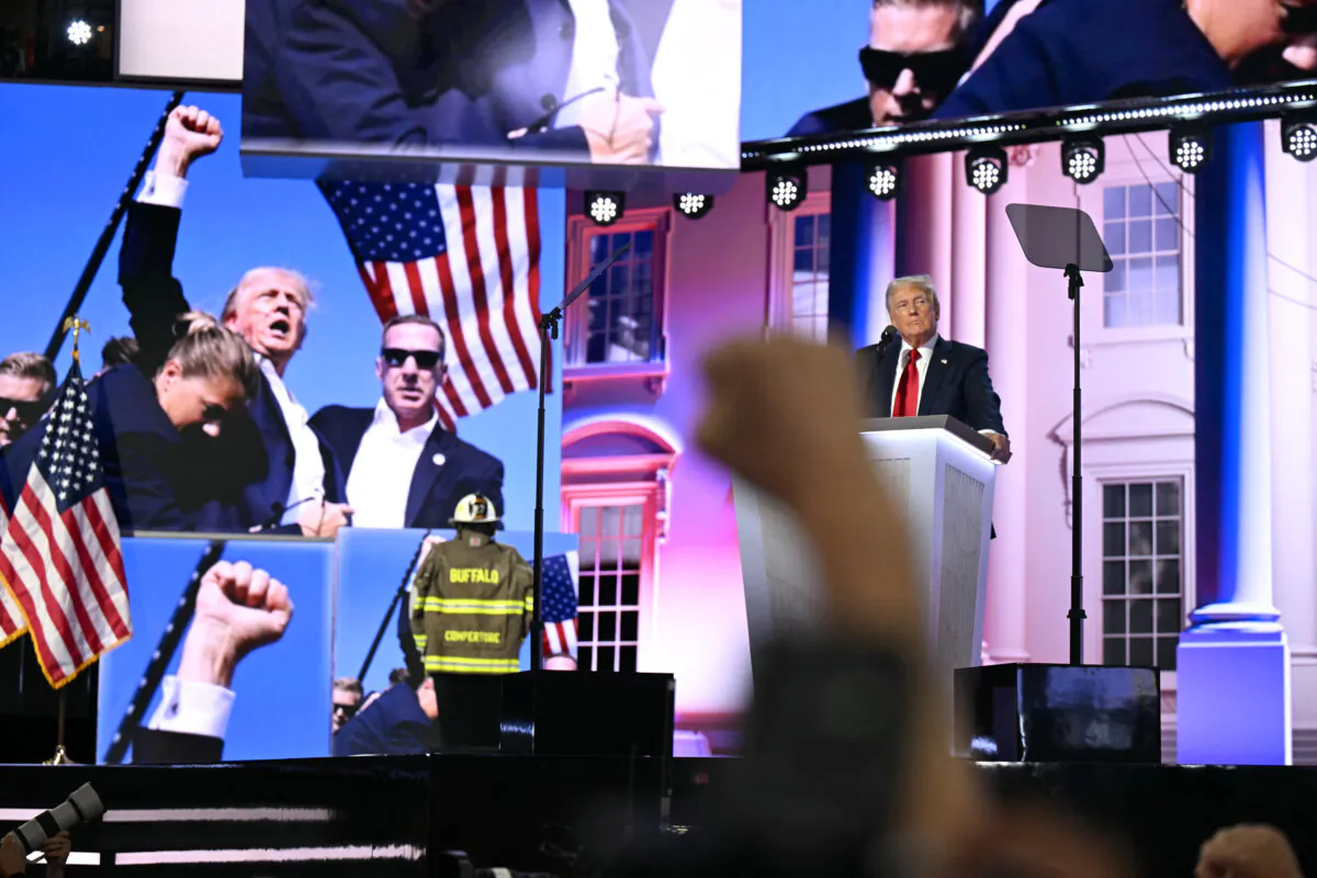 Images of the attempted assassination attempt on former President and 2024 Republican presidential candidate Donald Trump are seen on a screen as he speaks during the last day of the 2024 Republican National Convention at the Fiserv Forum in Milwaukee, Wis., on July 18, 2024. (Patrick T. Fallon/AFP via Getty Images)