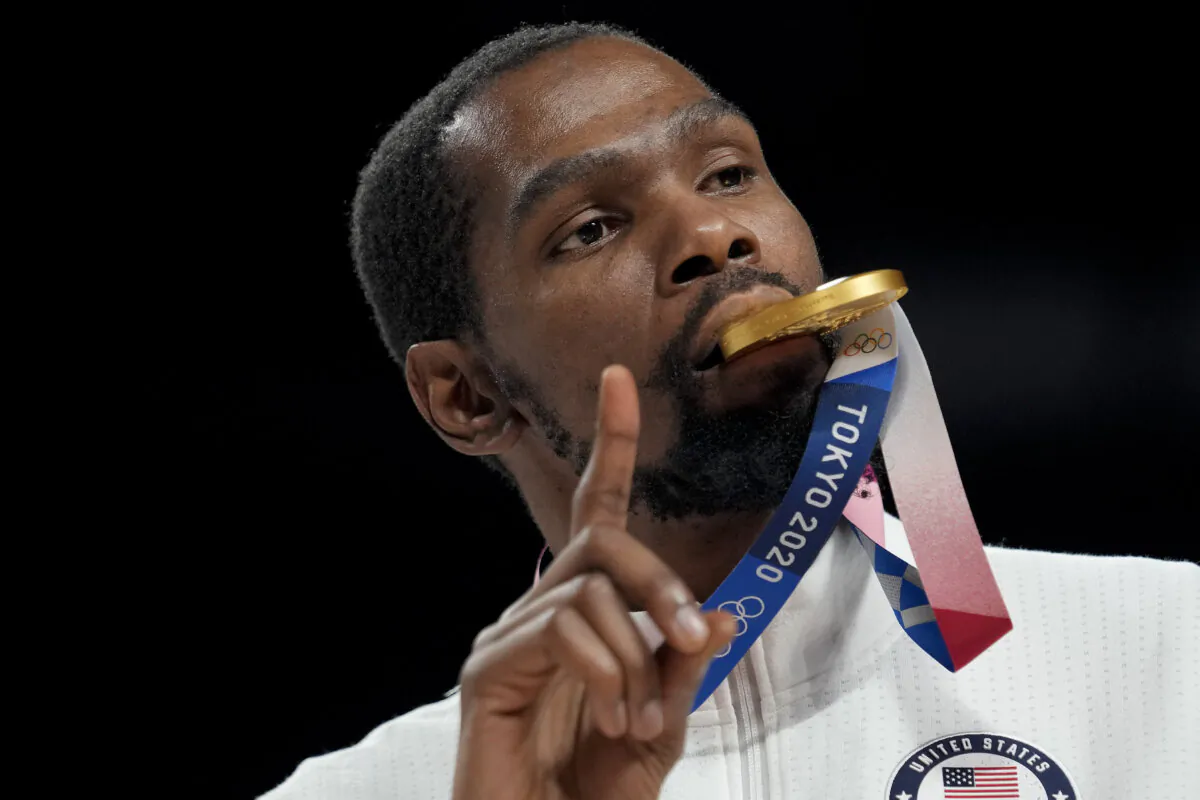Kevin Durant poses for a photo with his gold medal during the medal ceremony for basketball game at the 2020 Summer Olympics, Aug. 7, 2021, in Tokyo, Japan. (AP Photo/Eric Gay)