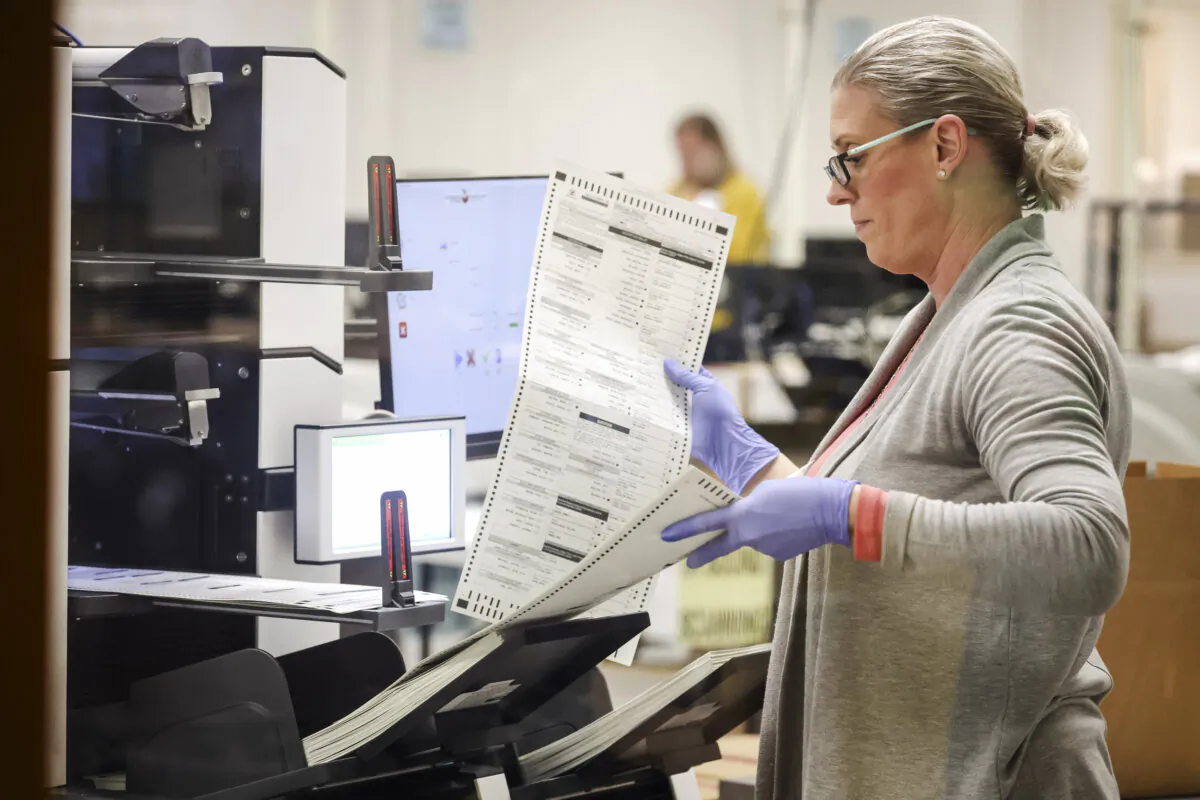 An election worker scans mail in ballots at the Maricopa County Tabulation and Election Center in Phoenix, Ariz., on on November 7, 2022 (Justin Sullivan/Getty Images)