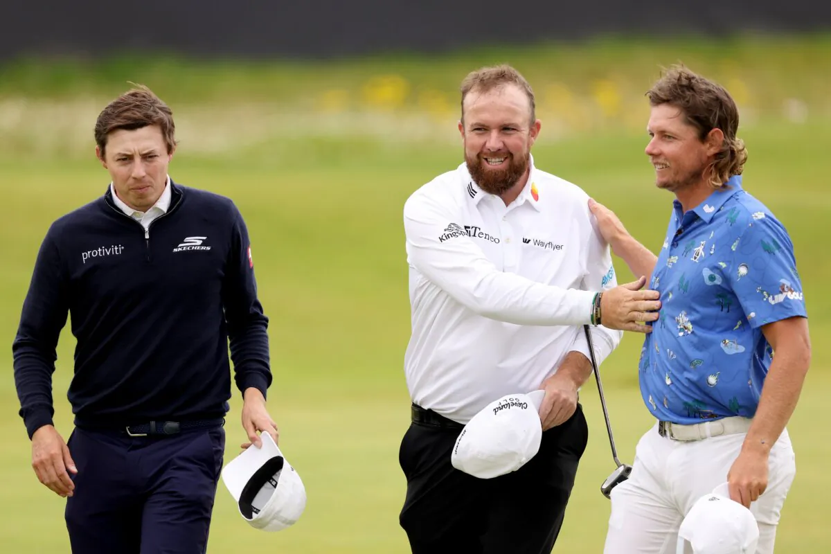 Shane Lowry of Ireland interacts with Cameron Smith of Australia and Matt Fitzpatrick of England after finishing their round on the 18th green during day two of The 152nd Open championship at Royal Troon in Troon, Scotland, on July 19, 2024. (Kevin C. Cox/Getty Images)