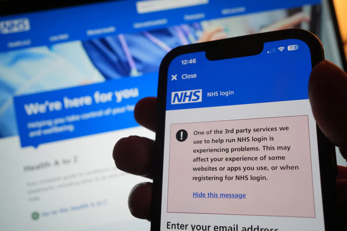 A warning message on the NHS app displayed on a phone as widespread IT outages are affecting businesses and institutions around the globe on July 19, 2024. (Yui Mok/PA Wire)