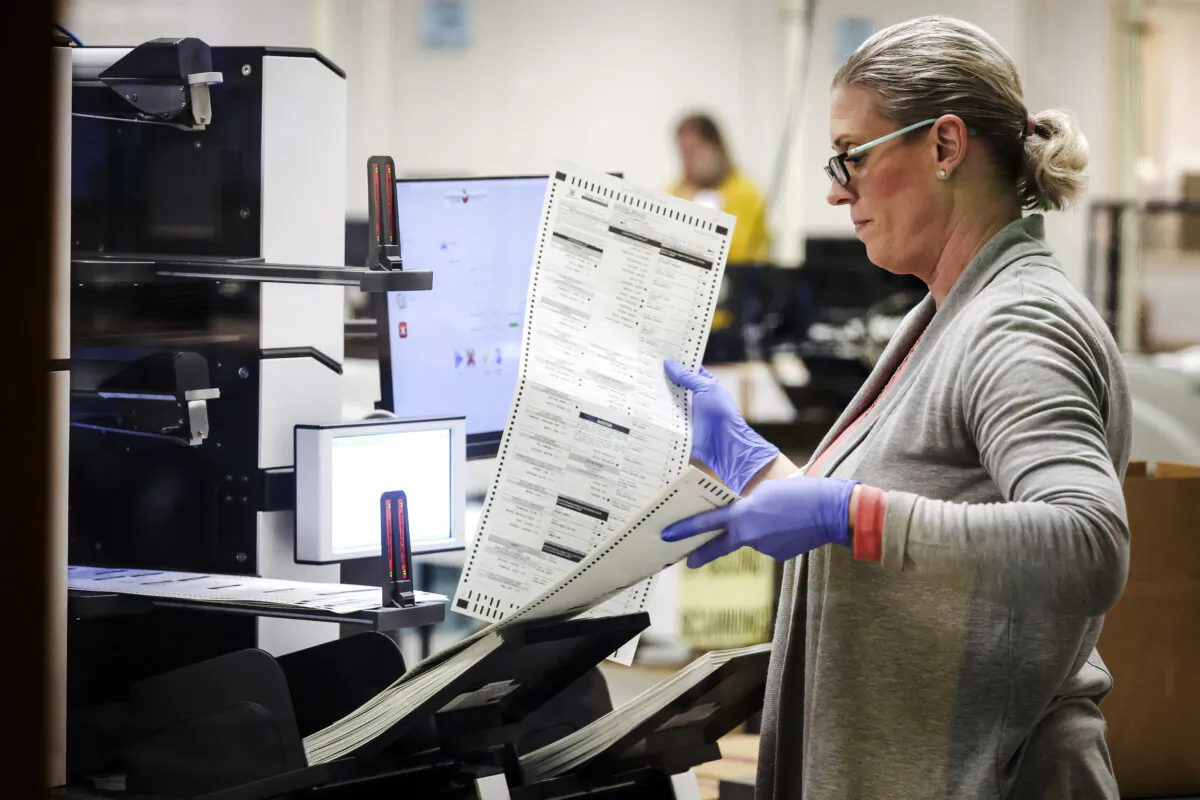 An election worker scans mail in ballots at the Maricopa County Tabulation and Election Center in Phoenix, Ariz., on Nov. 7, 2022. (Justin Sullivan/Getty Images)