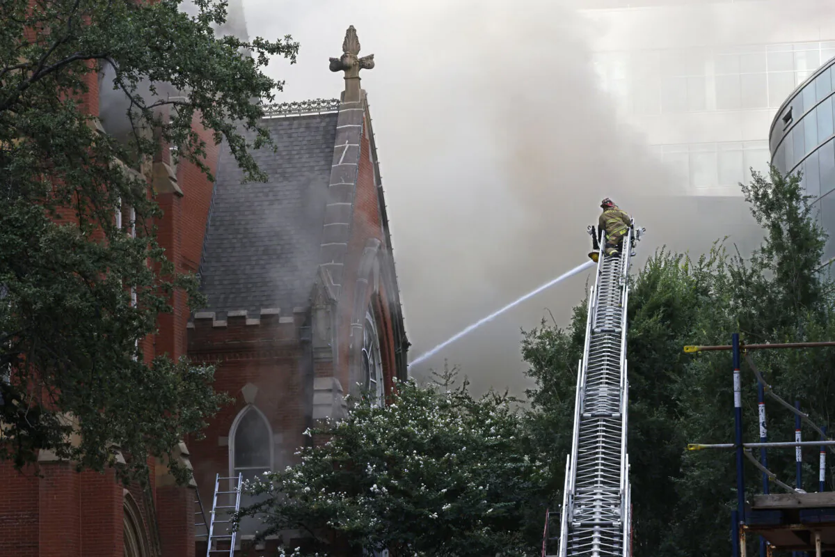 Firefighters work at the scene of a fire at First Baptist Dallas church in downtown Dallas on July 19, 2024. (Chitose Suzuki/The Dallas Morning News via AP)