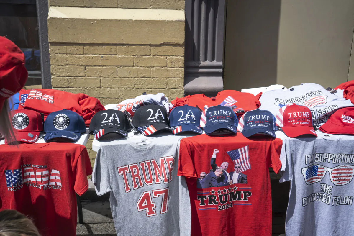 Vendors sell t-shirts and other merchandise ahead of former President Donald J. Trump and Vice President nominee Sen. JD Vance’s first rally since they were nominated at the Republican National Convention in Grand Rapids, Mich., on July 20, 2024. (Madalina Vasiliu/The Epoch Times)