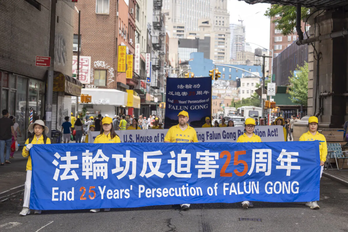 Falun Gong practitioners march during a parade calling for the end of the Chinese Communist Party’s 25 years of ongoing persecution against the spiritual practice, in New York City on July 20, 2024. (Samira Bouaou/The Epoch Times)