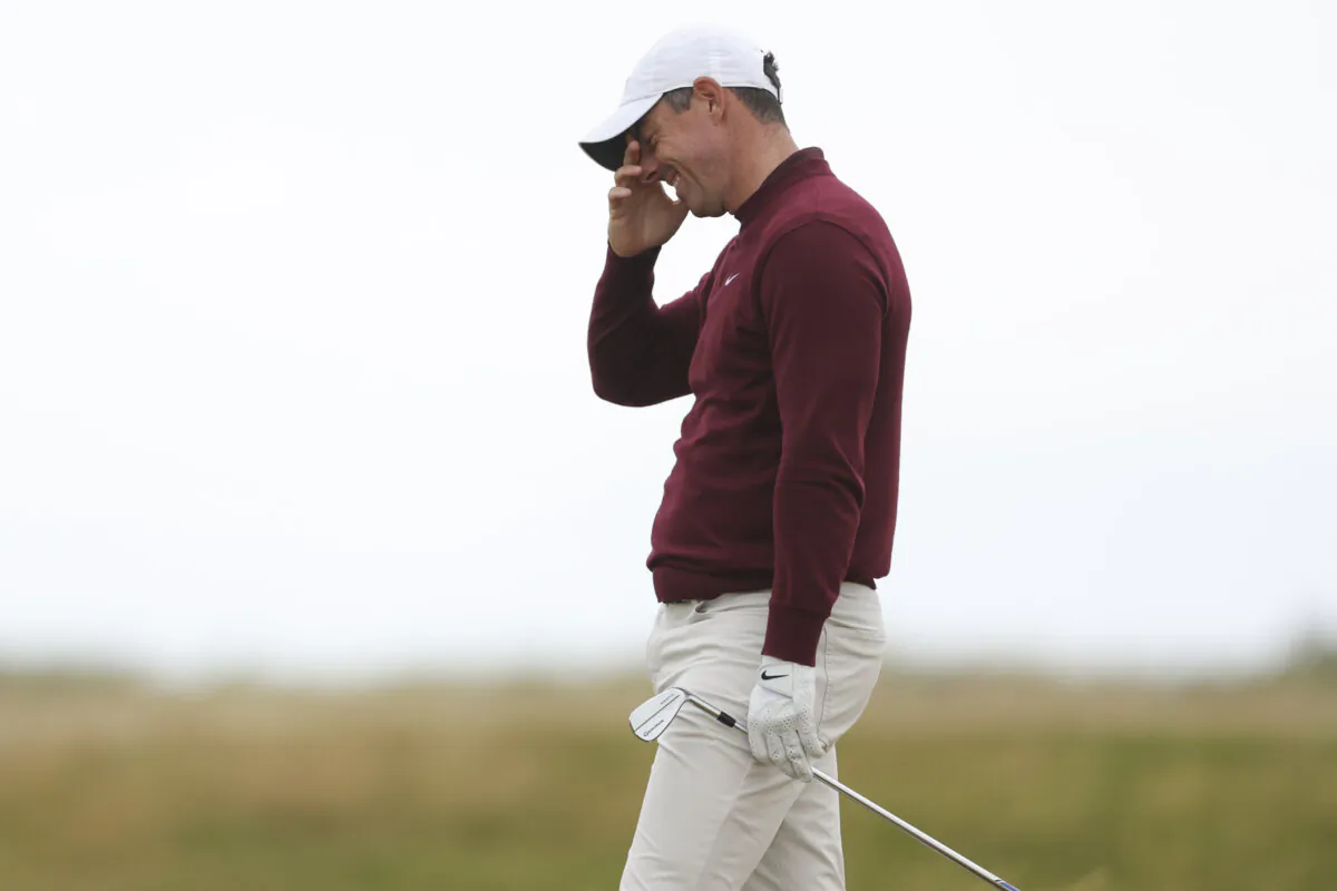 Rory McIlroy of Northern Ireland reacts after playing from the rough on the third hole during his second round of the British Open Golf Championships at Royal Troon golf club in Troon, Scotland, on July 19, 2024. (Peter Morrison/AP Photo)