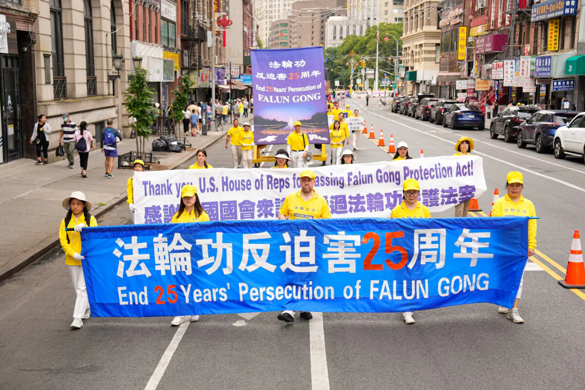Falun Gong practitioners march during a parade calling for the end of the Chinese Communist Party’s 25 years of ongoing persecution against the spiritual practice, in New York City on July 20, 2024. (Larry Dye/The Epoch Times)