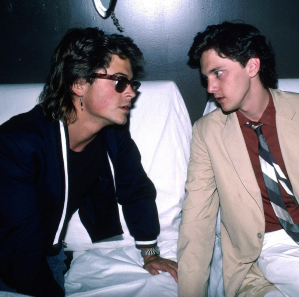Two young men on beds in BRATS