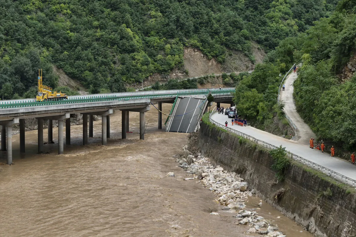 Rescuers work near a collapsed bridge in Zhashui county in Shangluo city, northwest China's Shaanxi Province, on July 20, 2024. Chinese authorities say several people have died and more than dozen are missing in the partial collapse of a highway bridge in the northwest of the country following heavy storms and flooding. (Zhao Yingbo/Xinhua via AP)