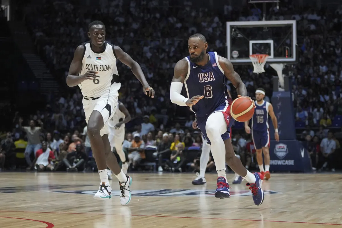 United States' forward LeBron James runs as he advances to score as South Sudan's center Khaman Maluach attempts to defend during an exhibition basketball game between the United States and South Sudan, in London on July 20, 2024. (Kin Cheung/AP Photo)