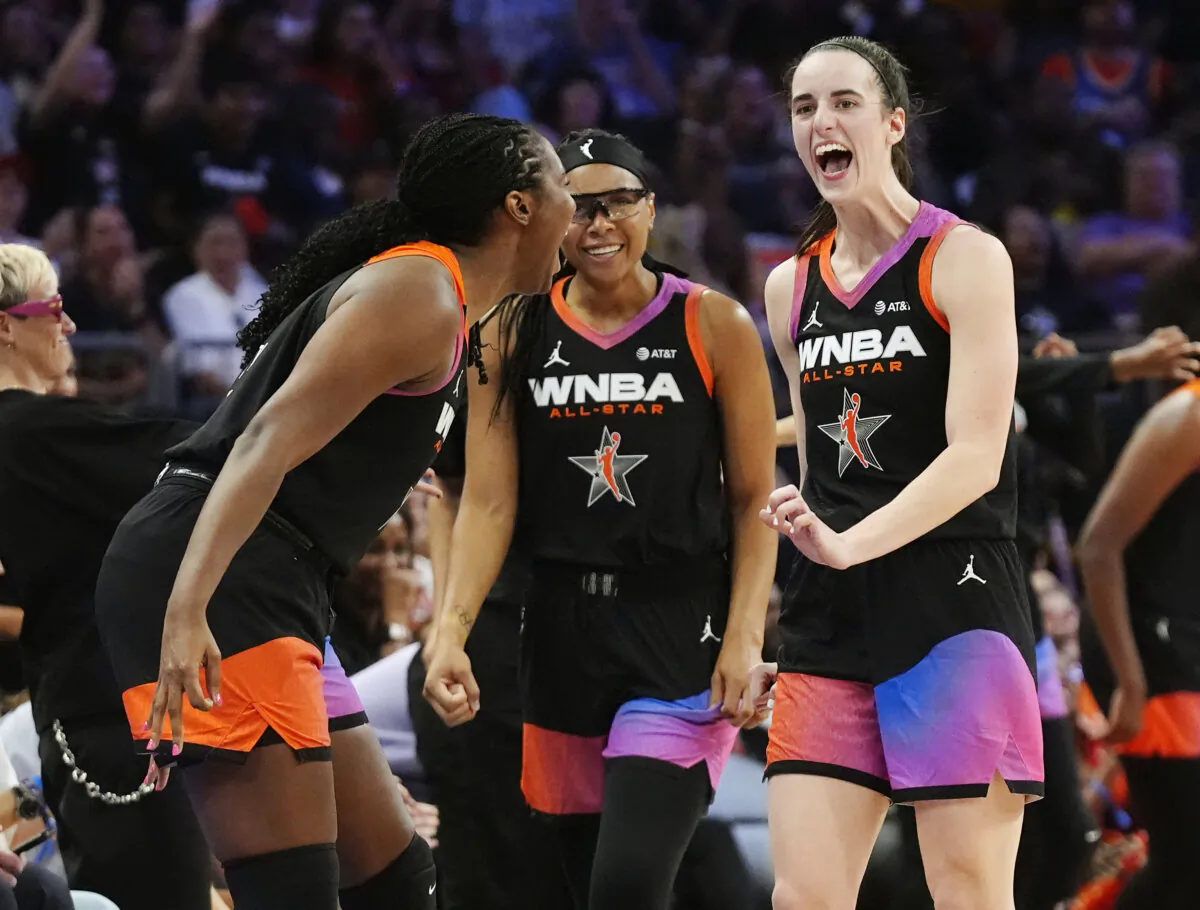 Caitlin Clark (R), Allisha Gray (C), and Aliyah Boston (L) of Team WNBA celebrate a 3-point basket by a teammate against Team USA during the WNBA All-Star game in Phoenix on July 20, 2024. (Ross D. Franklin/AP Photo)