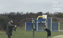 Older Gentleman Pushes Dog on Spinning Seesaw