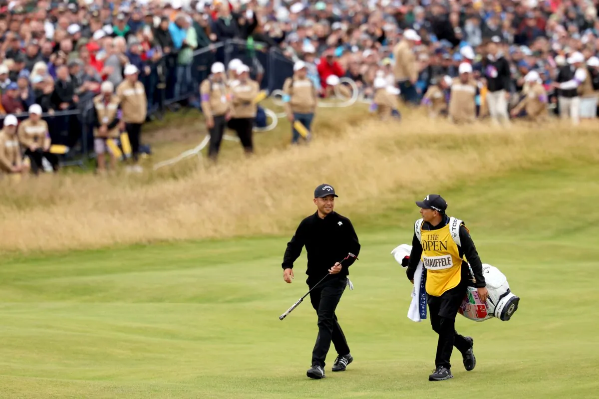 Xander Schauffele walks with his caddie, Austin Kaiser, on the 18th fairway during the final round of the Open championship in Troon, Scotland, on July 21, 2024. (Kevin C. Cox/Getty Images)