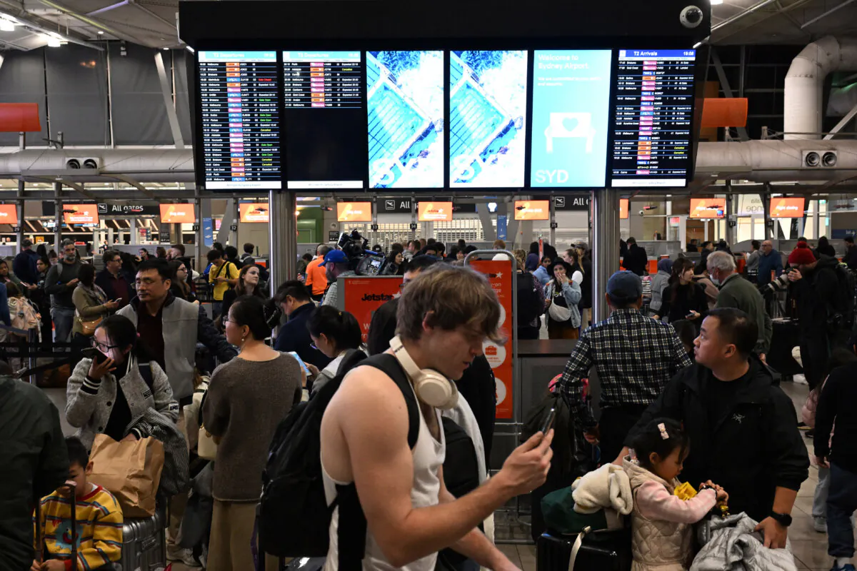Travellers wait in long service lines at the Sydney domestic airport in Sydney, Australia, on July 19, 2024. (Saeed Khan/AFP via Getty Images)