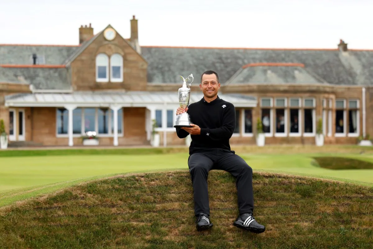 Xander Schauffele of the United States poses with the Claret Jug on the 18th hole in celebration of victory during day four of The 152nd Open championship at Royal Troon  in Troon, Scotland, on July 21, 2024. (Andrew Redington/Getty Images)