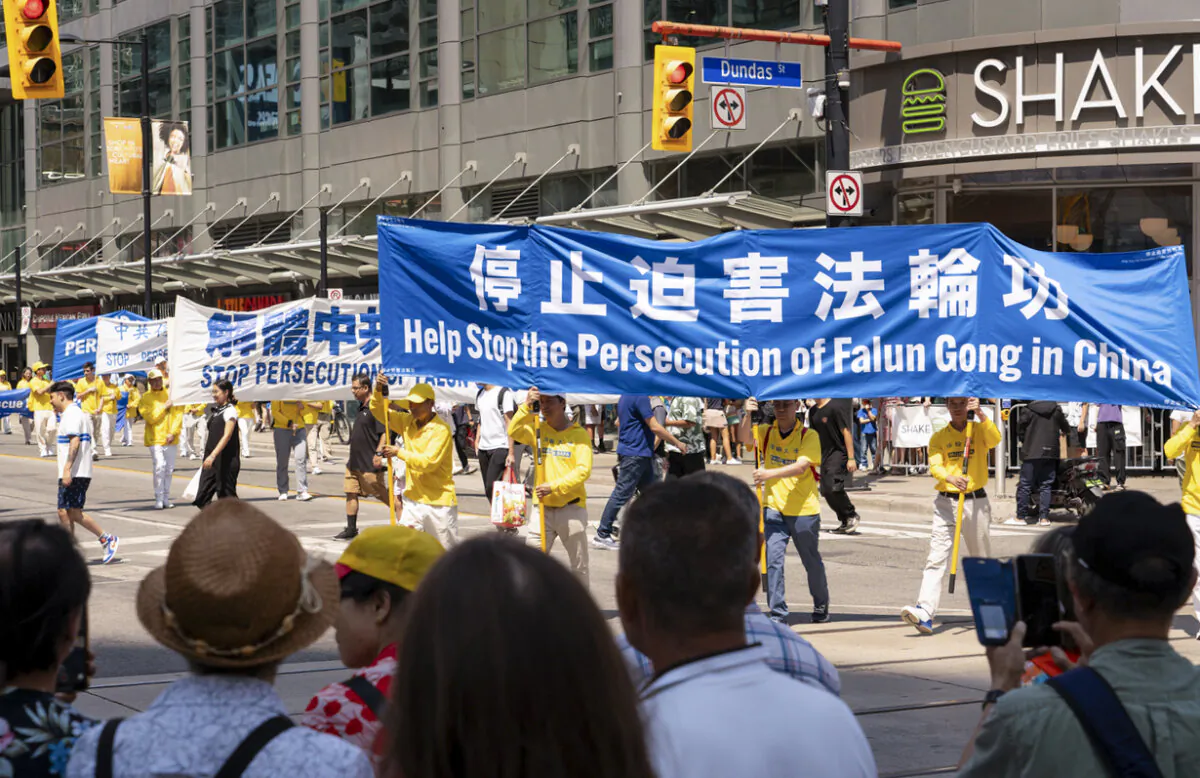 Falun Gong practitioners participate in a parade in downtown Toronto on July 20, 2024, marking the 25th anniversary of the Chinese regime's persecution of the spiritual practice. (Evan Ning/The Epoch Times)