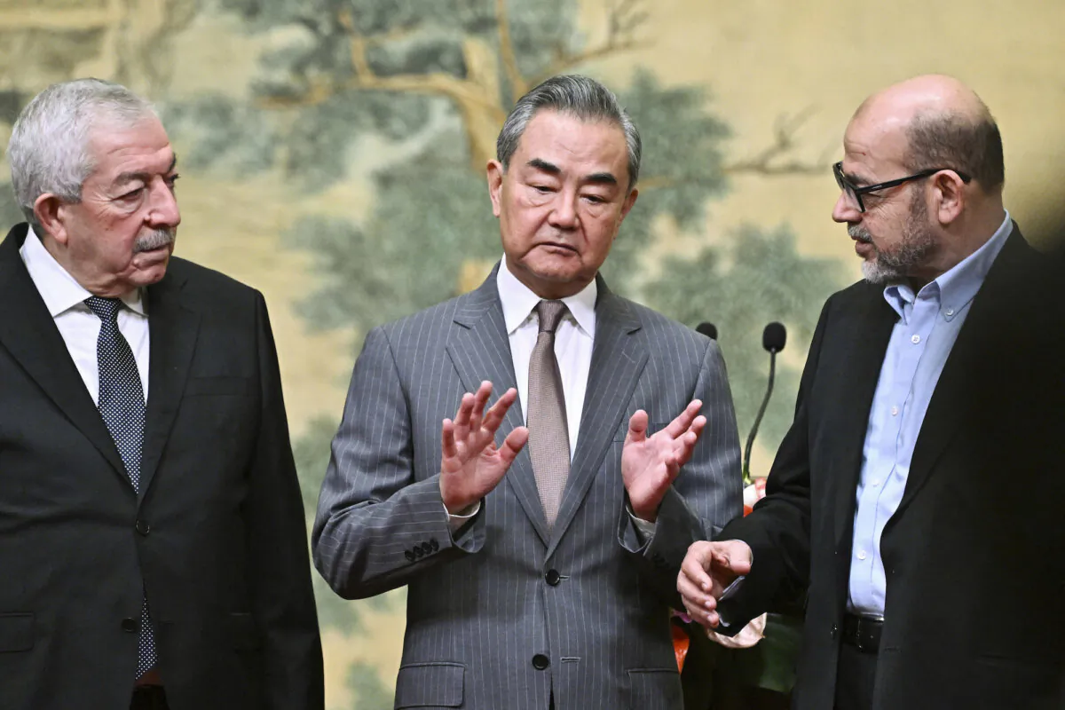 China's Foreign Minister Wang Yi (C), hosts an event for Mahmoud al-Aloul (L), vice chairman of Fatah, and Mussa Abu Marzuk (R), a senior member of Hamas, at the Diaoyutai State Guesthouse in Beijing on July 23, 2024. (Pedro Pardo/Pool Photo via AP)