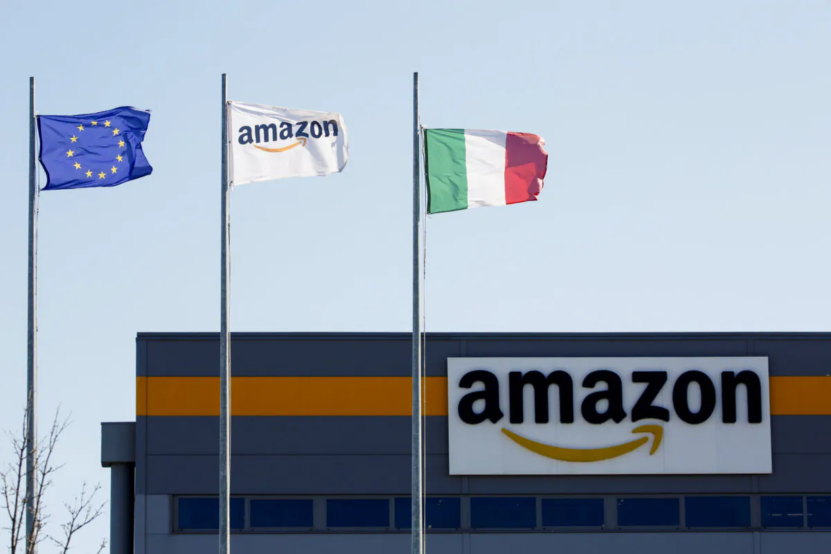 Flags flutter outside a distribution center at Amazon's logistics operations in Passo Corese, Italy, on March 22, 2021. (Remo Casilli/Reuters)