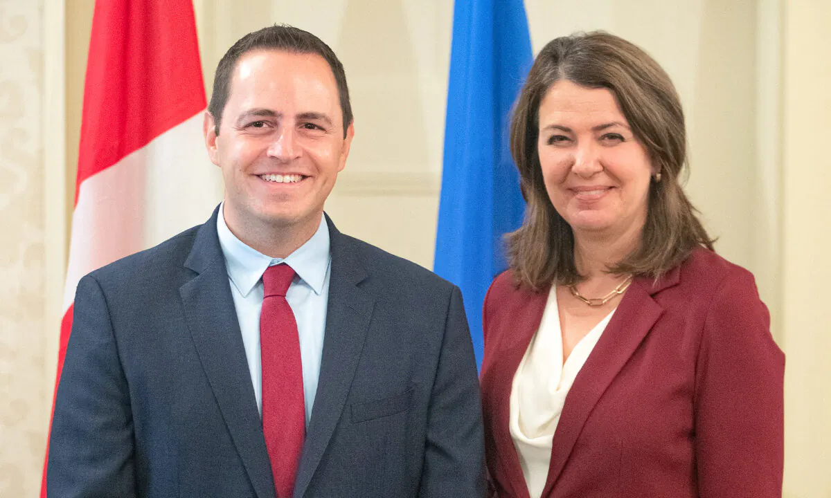 Alberta Premier Danielle Smith and Minister of Education Demetrios Nicolaides stand together during the swearing in of her cabinet in Edmonton, June 9, 2023. (Jason Franson/The Canadian Press)