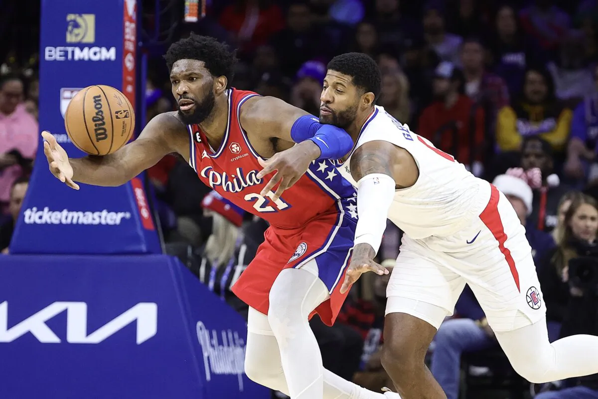 Paul George (13) of the LA Clippers guards Joel Embiid (21) of the Philadelphia 76ers during the second quarter in Philadelphia on Dec. 23, 2022. (Tim Nwachukwu/Getty Images)