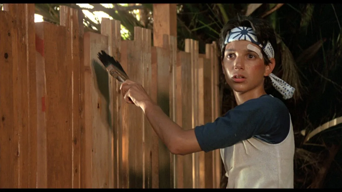 Daniel (Ralph Macchio) learns karate by painting a fence, in "The Karate Kid."(Columbia Pictures)