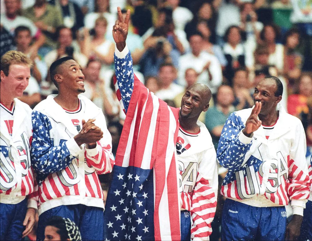 U.S. basketball player Michael Jordan (2nd R) flashes a victory sign as he stands with team mates Larry Bird (L), Scottie Pippen and Clyde Drexler (R), nicknamed the "Dream Team" after winning the Olympic gold in Barcelona, Spain, on Aug. 8, 1992. (Ray Stubblebine/Reuters)