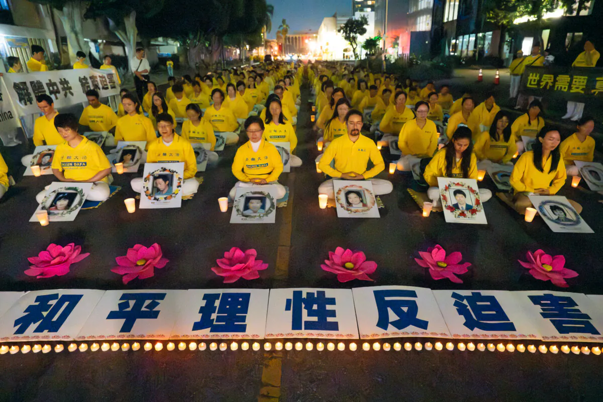 Falun Gong practitioners hold a candlelight vigil in front of the Chinese Consulate to mark 25 years of the Chinese Communist Party's persecution of Falun Gong in China, in Los Angeles on July 20, 2024. (Alex Lee/The Epoch Times)