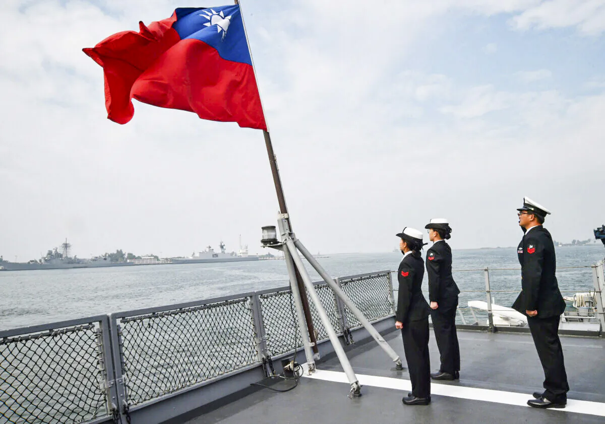 Taiwanese sailors salute the island's flag on the deck of the Panshih supply ship after taking part in annual drills at the Tsoying Naval Base in Kaohsiung, Taiwan, on Jan. 31, 2018. (Mandy Cheng/AFP via Getty Images)