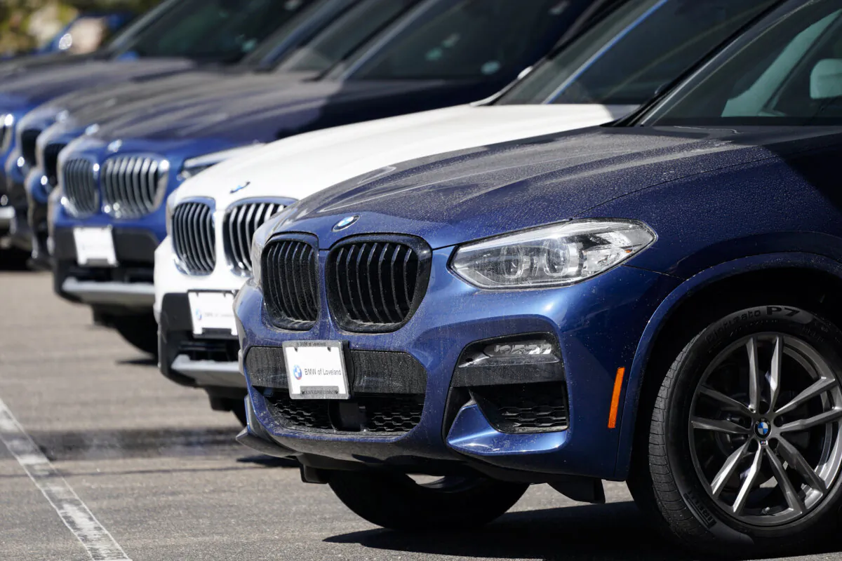 A long row of unsold 2021 X3 sports-utility vehicles sits at a BMW dealership in Loveland, Colo., on March 28, 2021. (AP Photo/David Zalubowski)