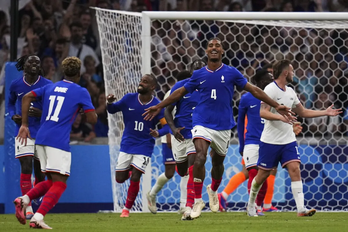 France's Loic Bade (4) celebrates scoring his side's third goal during the men's Group A soccer match between France and the United States in Marseille, France, on July 24, 2024. (Daniel Cole/AP Photo)